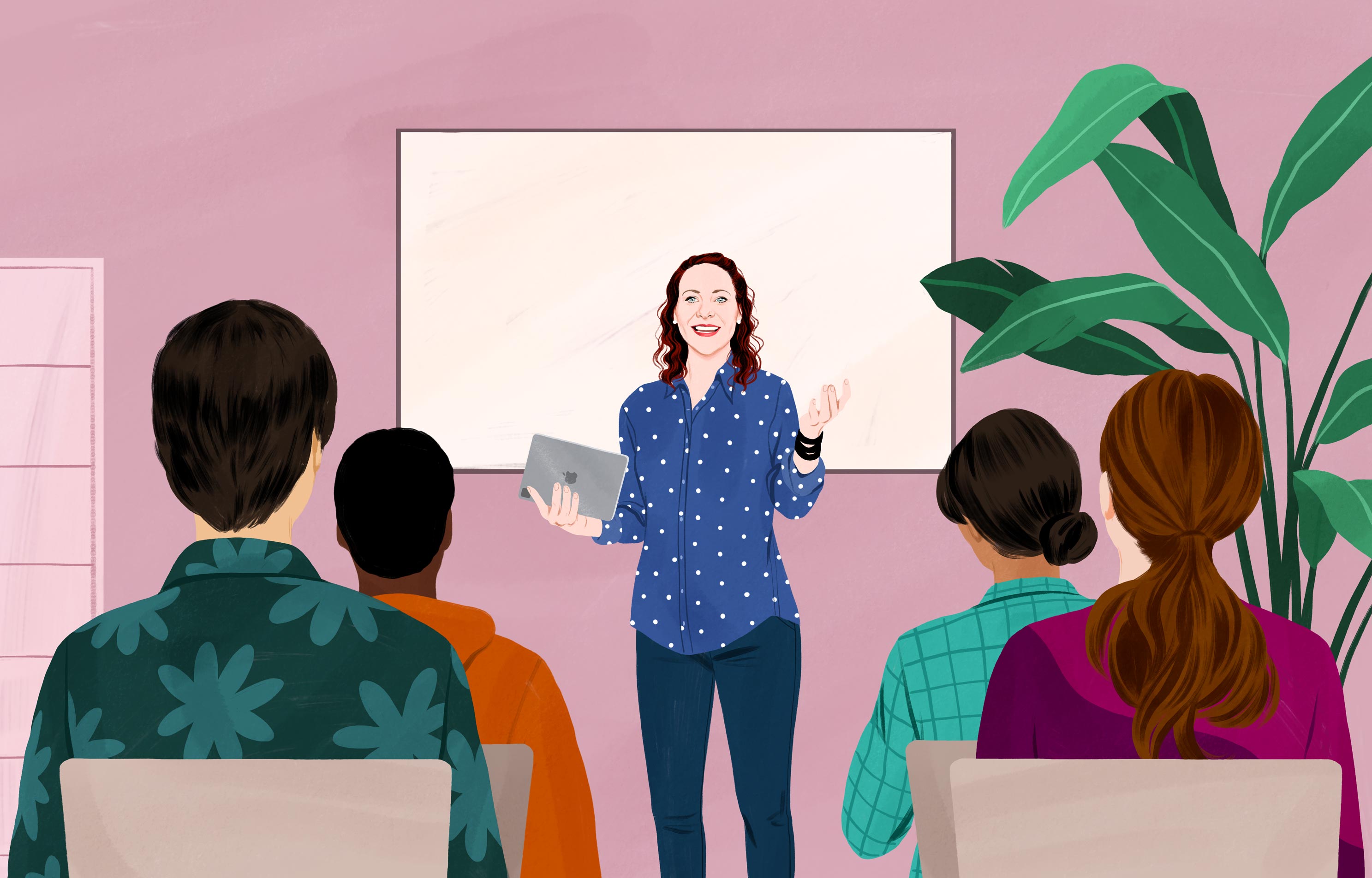 Usmívající se Jessica drží iPad, stojí před skupinou dospělých a gestikuluje, jako by něco vysvětlovala. 
