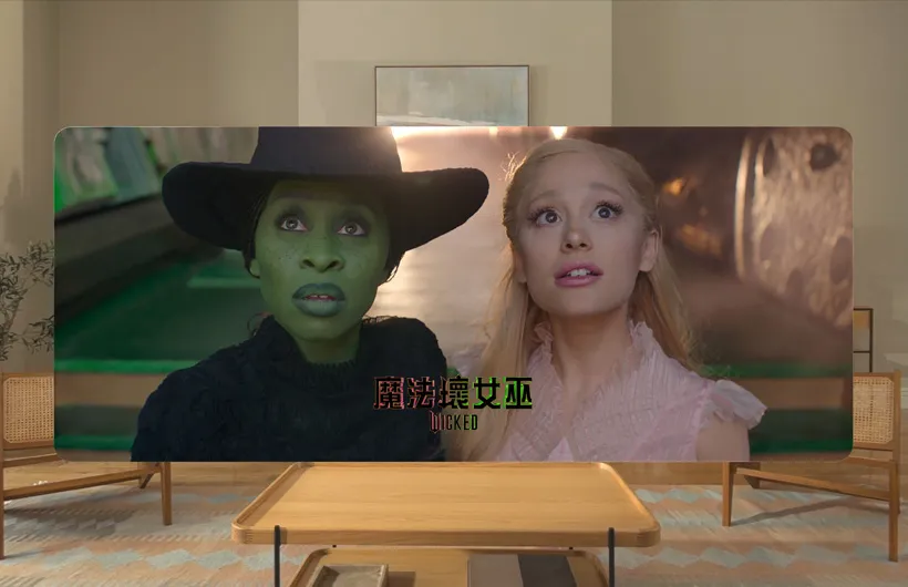 Two main characters from the film Wicked in the Apple TV app on Apple Vision Pro.