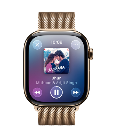 Apple Watch in Gold Titanium with Milanese Loop, face shows Apple Music playing, translucent Liquid Glass controls