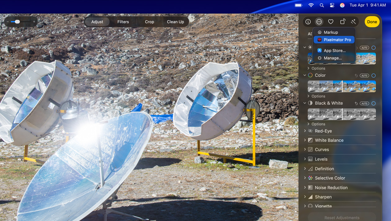 MacBook Pro 16 screen, photo of three silver space telescopes on the ground, image editing tools